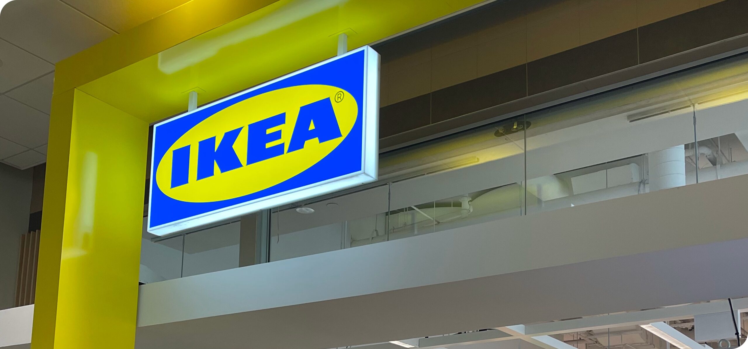 Close-up of the iconic blue and yellow IKEA sign mounted above the store entrance.