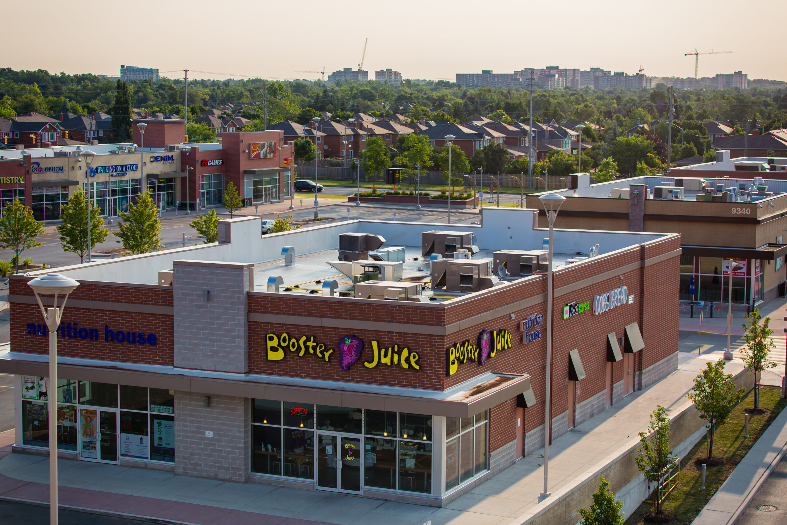 Aerial view of a corner building at Rutherford Market Place with multiple retail tenants and surrounding residential neighbourhoods.