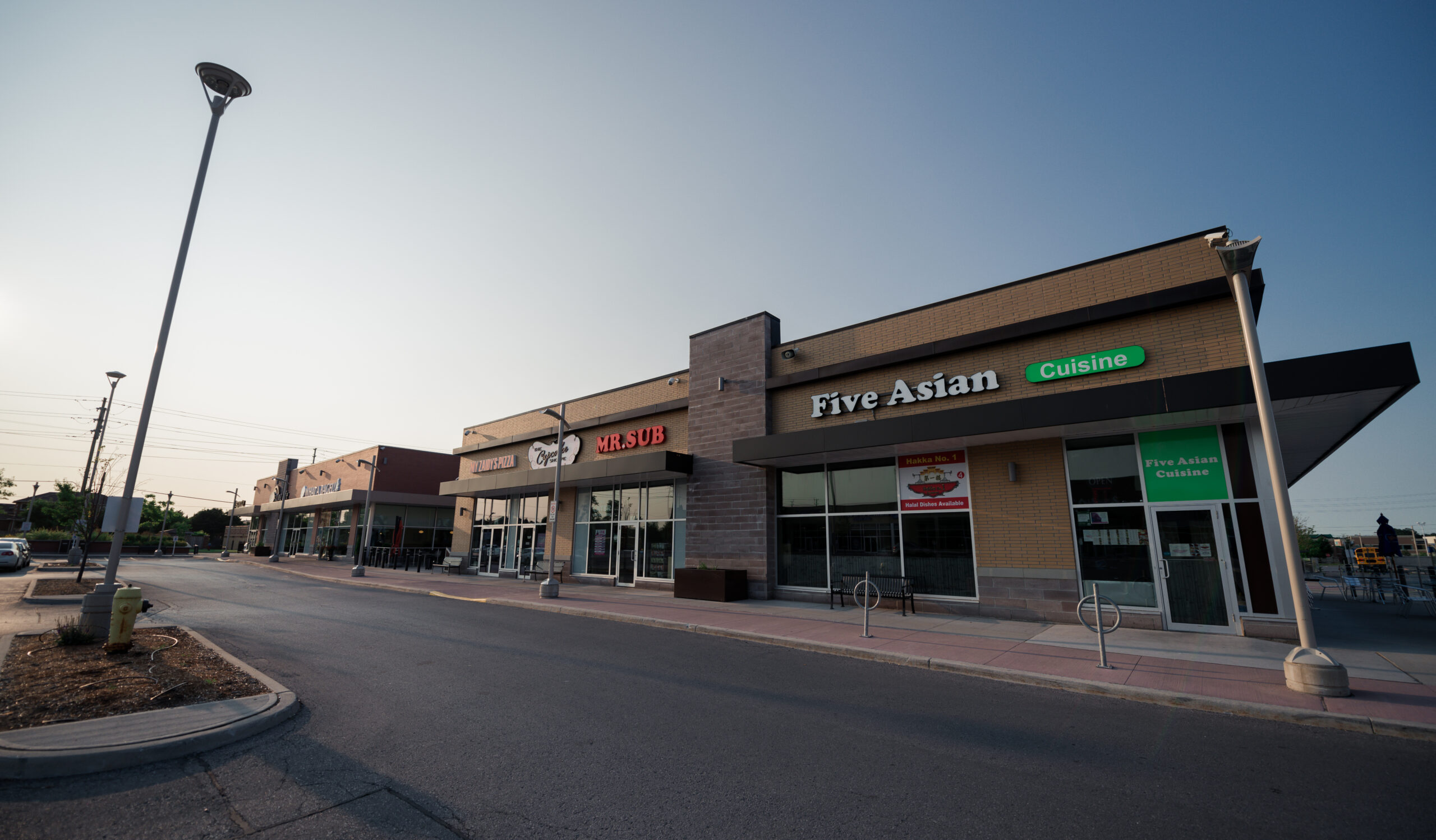 Exterior view of an inline retail row at Rutherford Market Place with restaurant and service storefronts.