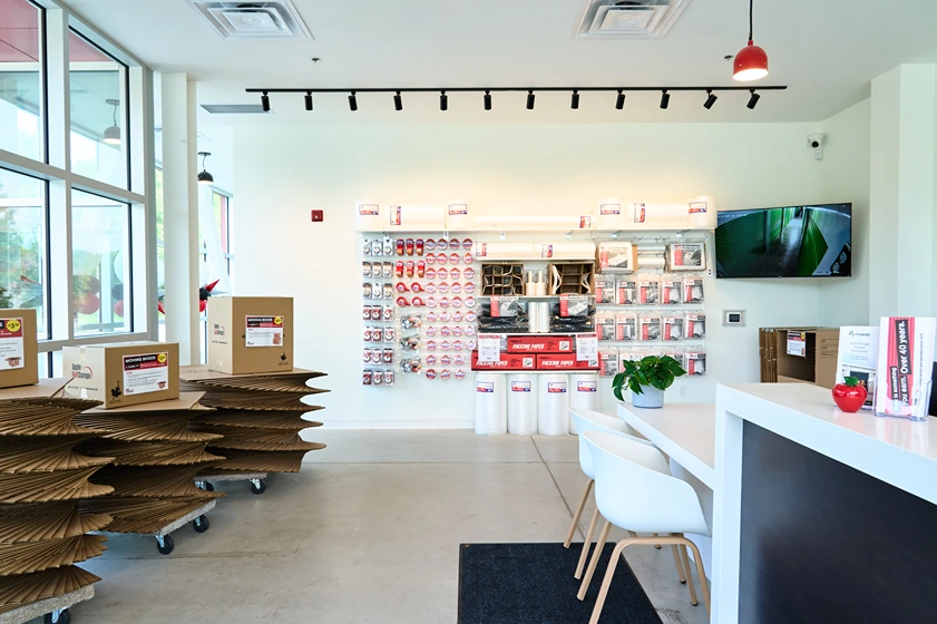 Interior of an Apple Self Storage retail area with moving supplies, packing materials, and a service counter.