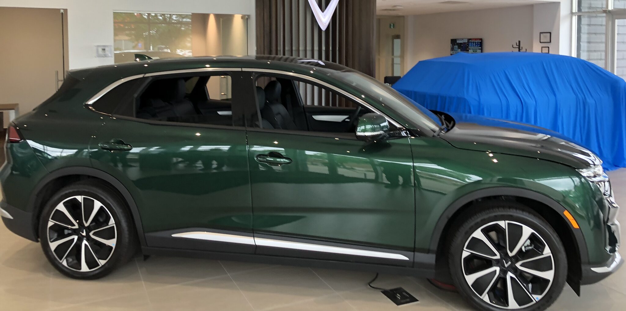 VinFast electric vehicle displayed inside the dealership showroom.