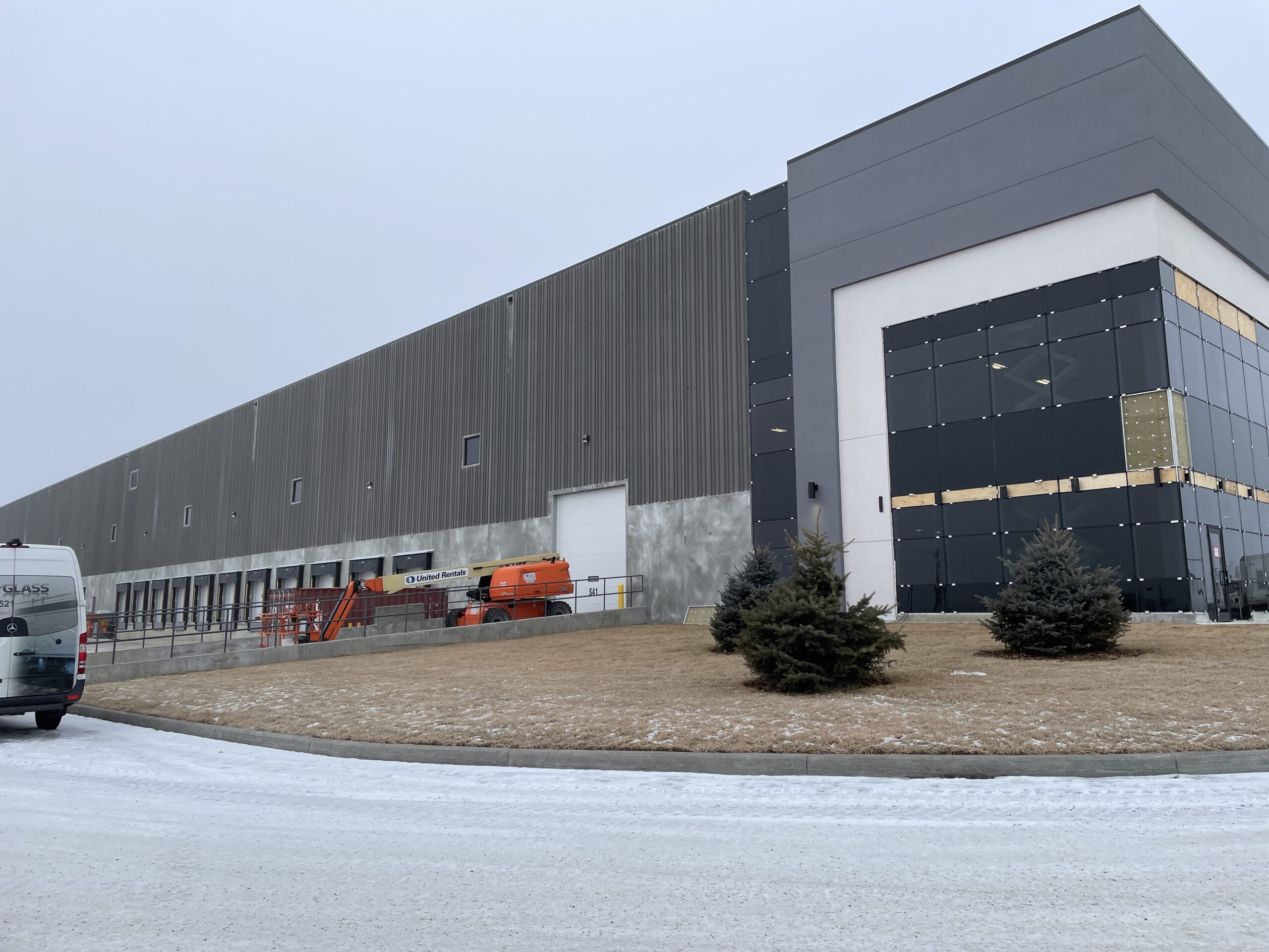 Exterior view of Building M at Border Business Park showing the warehouse structure, loading area, and adjacent service drive.