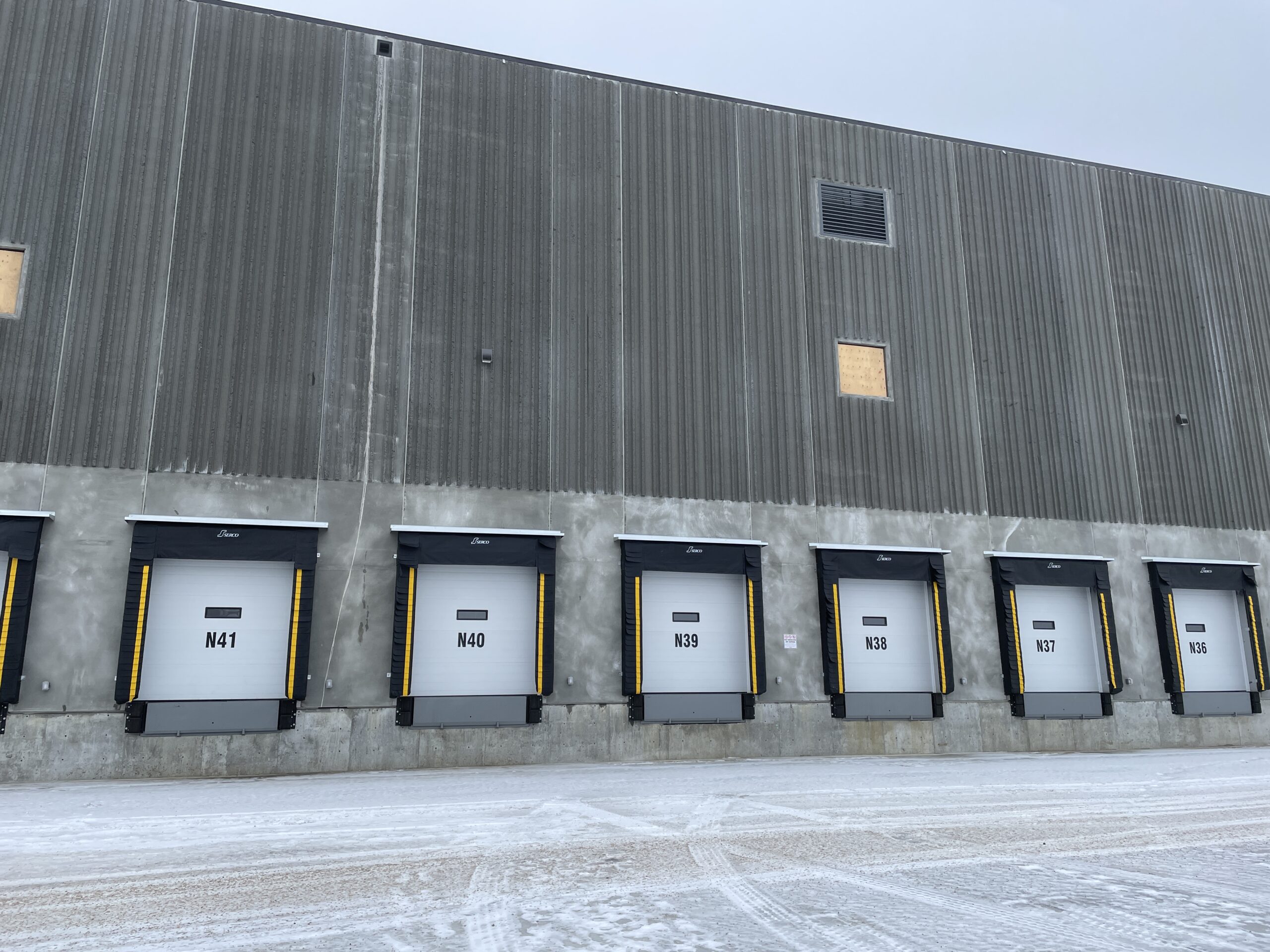 Loading dock area of Building M at Border Business Park with multiple dock doors and a concrete service yard.