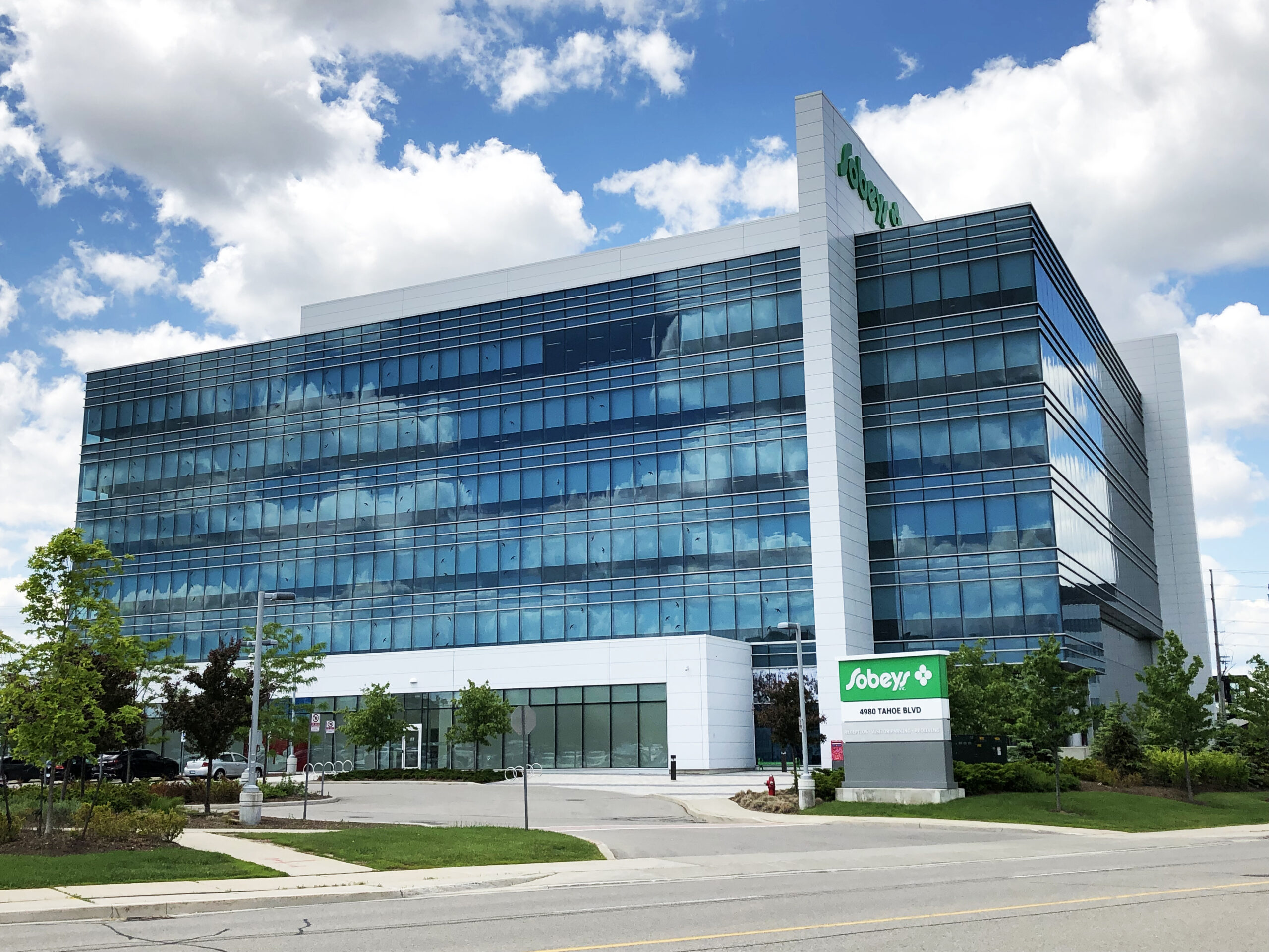 Exterior view of the Sobeys headquarters building with a glass façade and landscaped grounds.